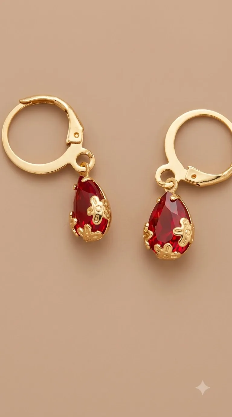 Gold-tone huggie hoop earrings with ruby-red teardrop stones and gold flower caps