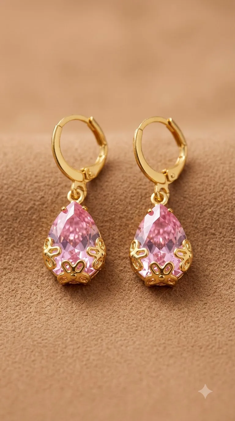 Gold-tone huggie hoop earrings with blush-pink teardrop stones